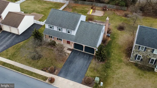 an aerial view of a house with pool