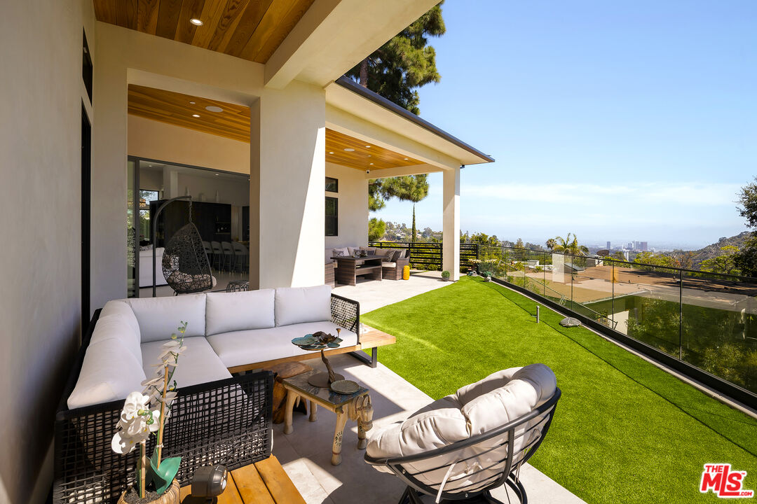 1367 Casiano Road Los Angeles, CA 90049 - Photo 23 of 26 a balcony with furniture and a lake view