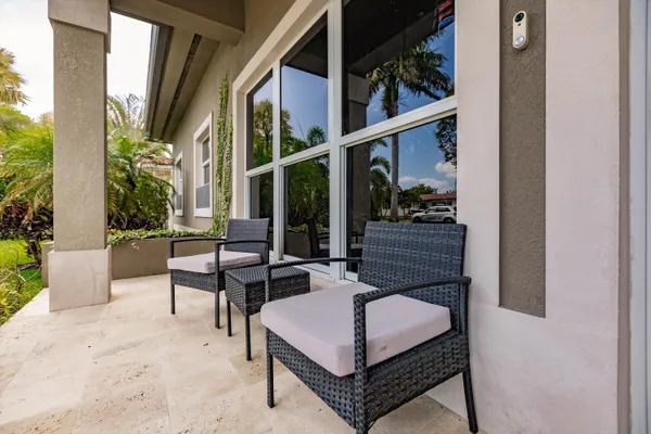 a view of two chairs in the balcony