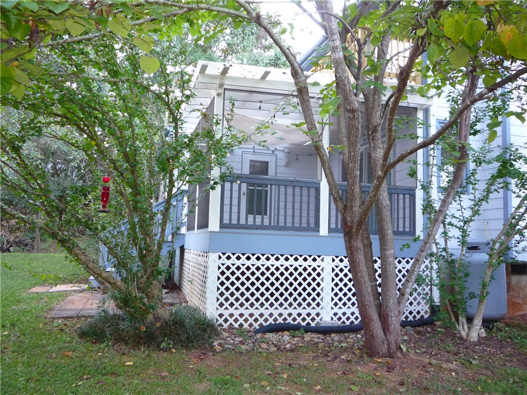 109 Lake Ridge Circle Walhalla, SC 29691 - Photo 8 of 27 Mature trees frame a charming screened porch with lattice underpinning.