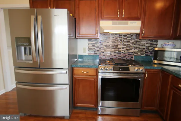 a kitchen with appliances and cabinets