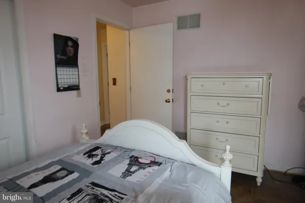 a bedroom with a bed and a dresser