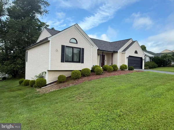 a front view of house with yard and green space