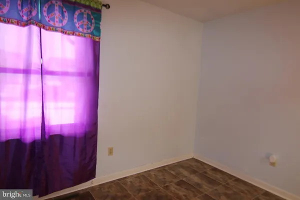 a bedroom with a bed and a flat tv screen on dresser