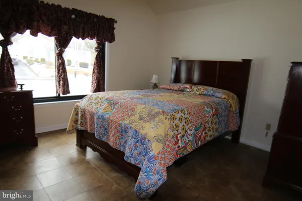 a bedroom with a bed and mirror