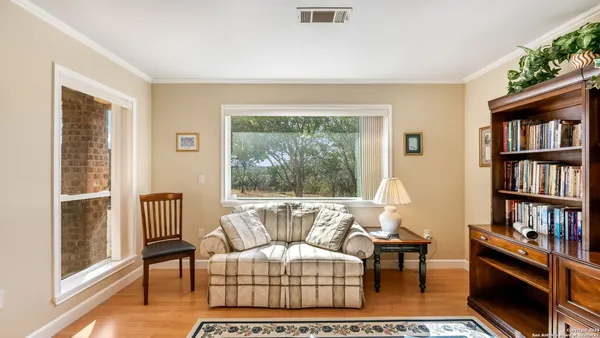 a living room with furniture and a book shelf