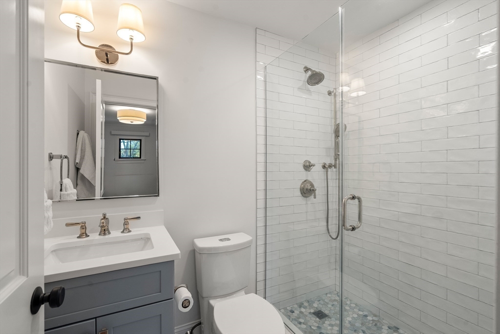 7 Massasoit Road Wellesley, MA 02481 - Photo 31 of 42 a bathroom with a toilet sink vanity and mirror
