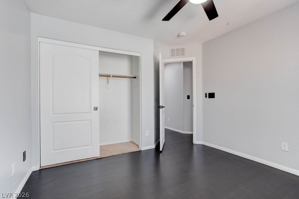7724 Vibrant Thread Court Las Vegas, NV 89149 - Photo 29 of 43 Ample closet storage and wood flooring characterize this inviting bedroom space.
