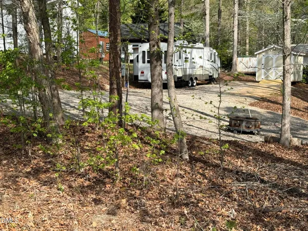 a view of a yard with cars