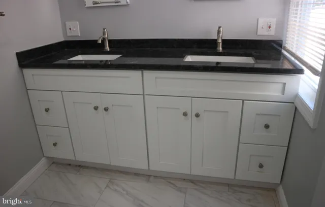 a kitchen with a sink and cabinets