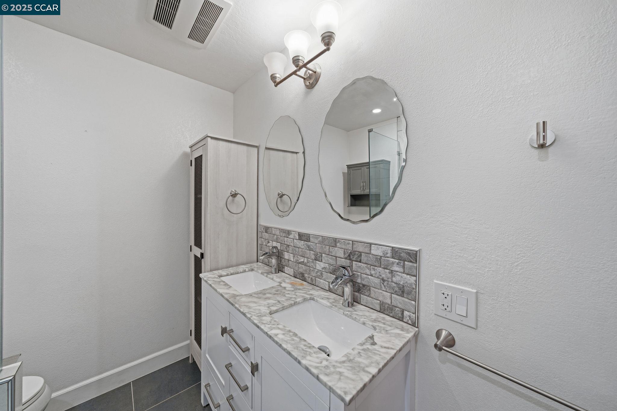 726 Grayson Road Pleasant Hill, CA 94523 - Photo 15 of 27 a bathroom with a sink a mirror and a light fixture