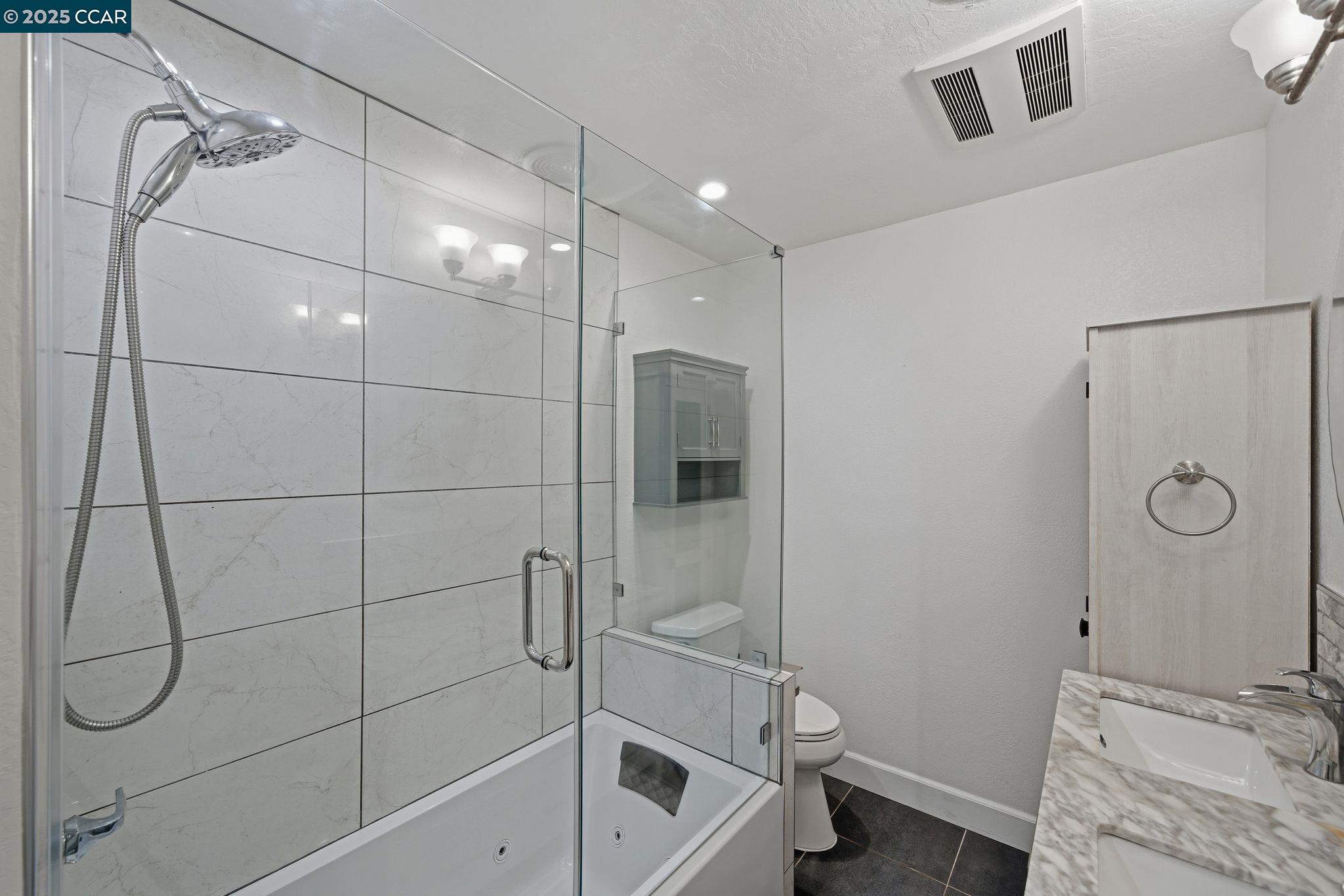 726 Grayson Road Pleasant Hill, CA 94523 - Photo 16 of 27 a bathroom with a granite countertop sink a toilet and shower