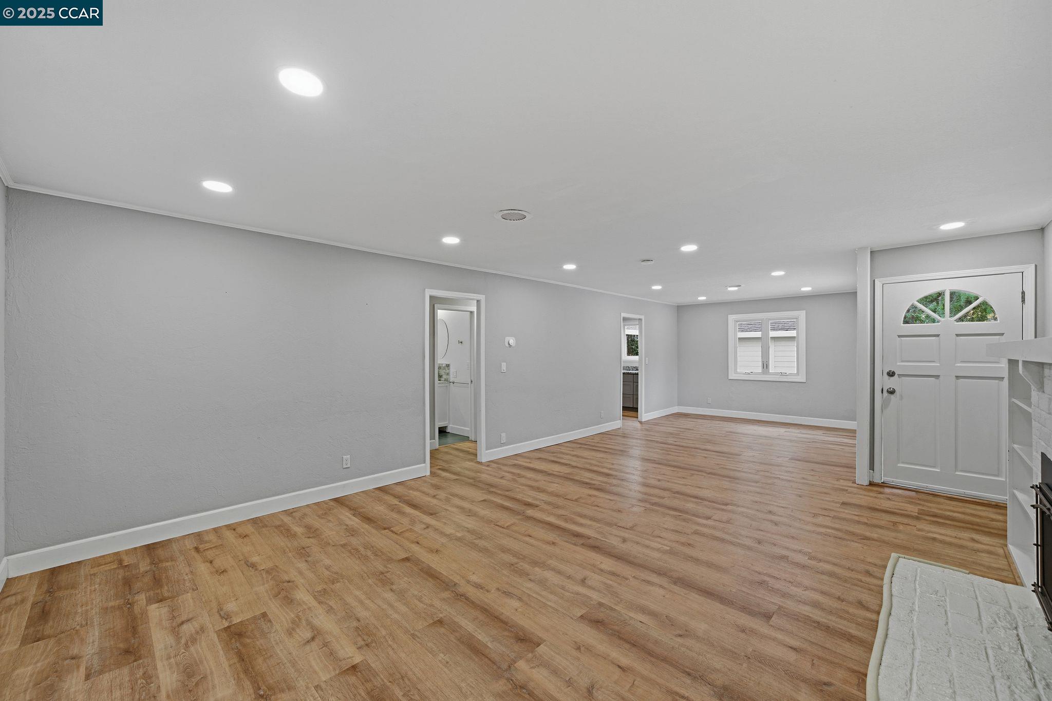 726 Grayson Road Pleasant Hill, CA 94523 - Photo 4 of 27 a view of an empty room with wooden floor and kitchen space
