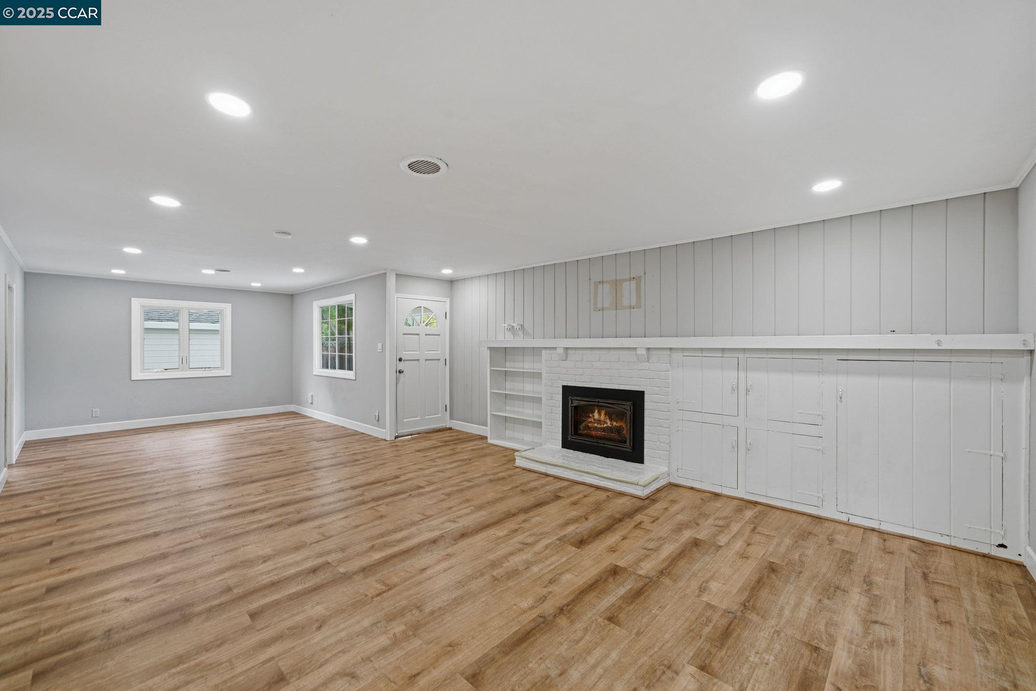 726 Grayson Road Pleasant Hill, CA 94523 - Photo 5 of 27 a view of empty room with wooden floor and fireplace