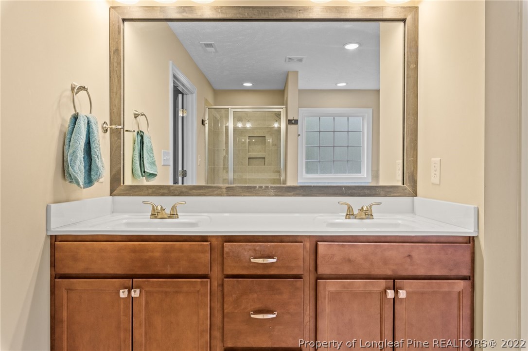 115 Dicks Hill Road Carthage, NC 28327 - Photo 16 of 38 a bathroom with a double vanity sink mirror and