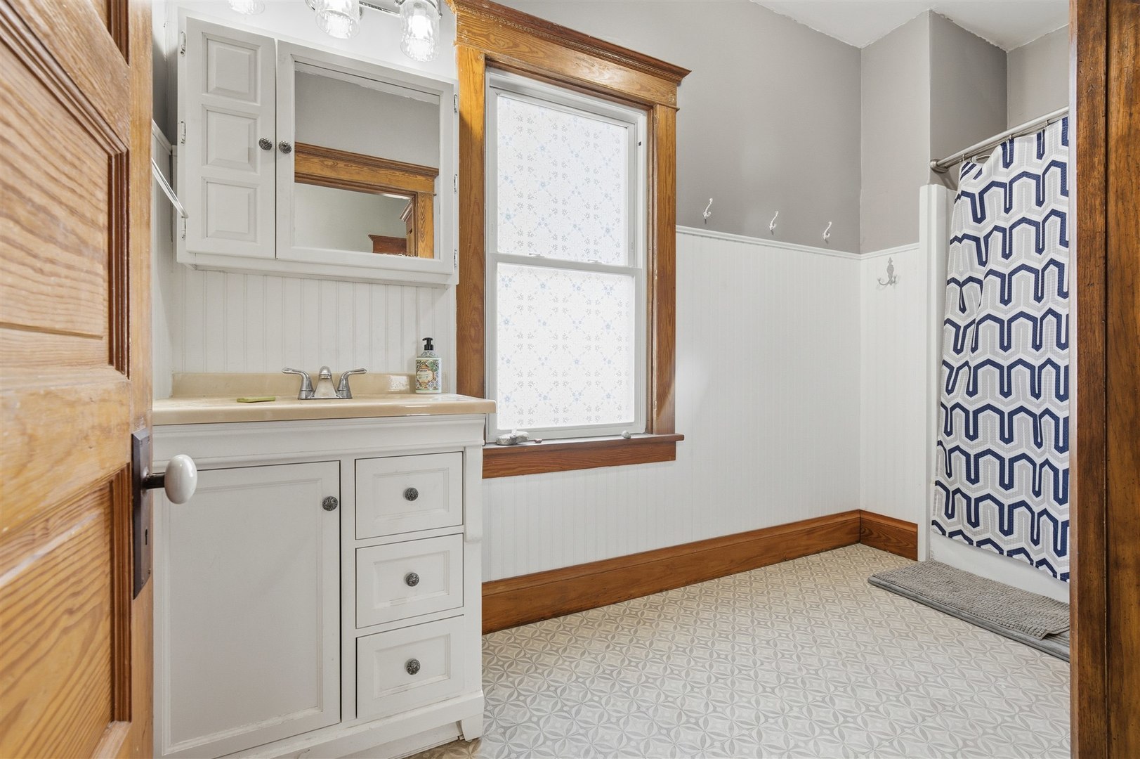 208 North Jackson Street Flanagan, IL 61740 - Photo 13 of 30 a bathroom with a granite countertop sink and a window
