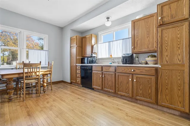 a kitchen with sink cabinets and wooden floor
