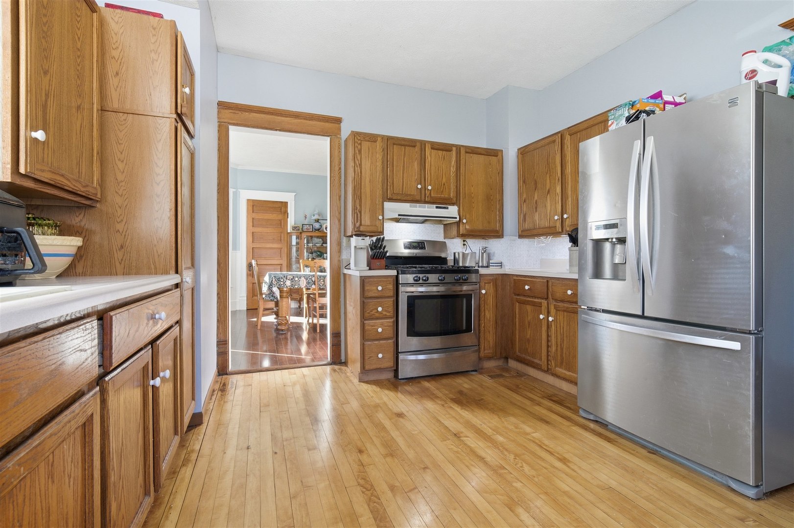 208 North Jackson Street Flanagan, IL 61740 - Photo 15 of 30 a kitchen with a refrigerator a stove top oven a sink dishwasher and wooden floor
