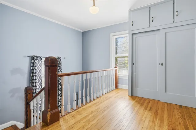a view of hallway with wooden floor