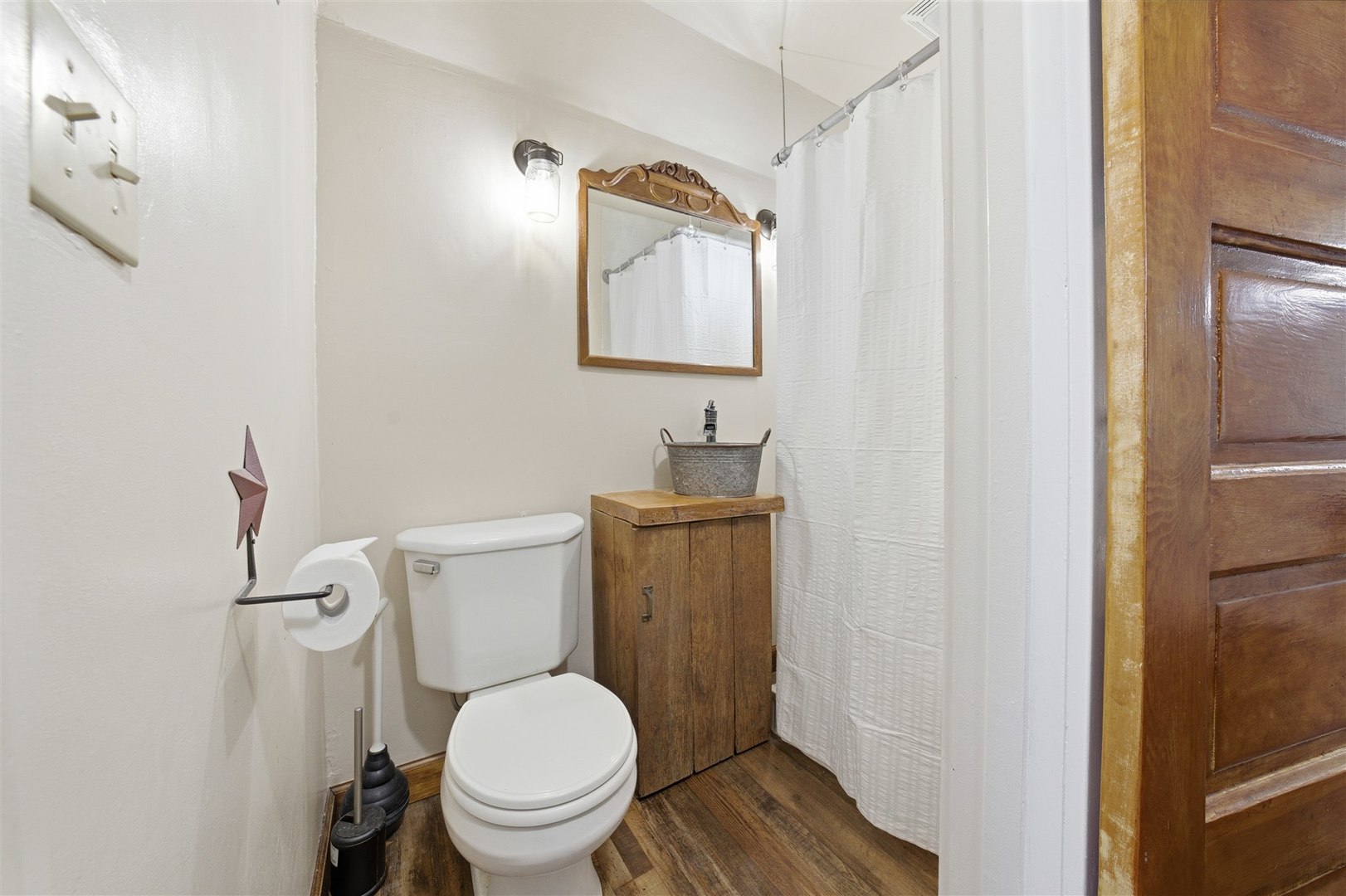208 North Jackson Street Flanagan, IL 61740 - Photo 21 of 30 a white toilet sitting next to a bathroom sink