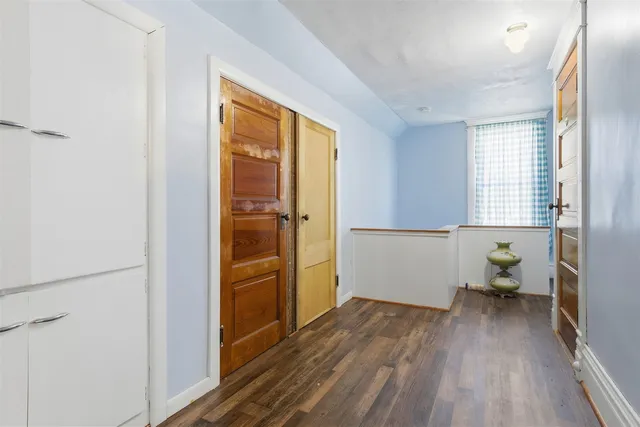 a view of hallway with wooden floor