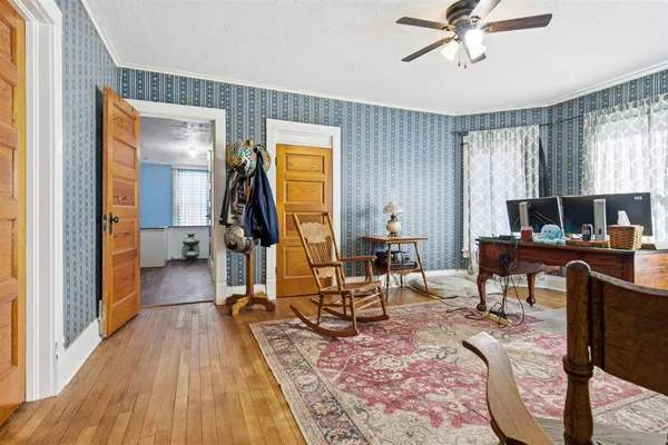 a view of a workspace with furniture and a window