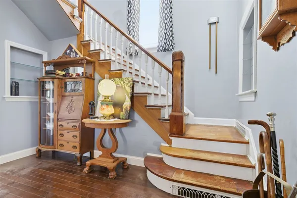 a view of staircase with wooden floor and windows