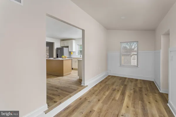 a kitchen with kitchen island a stove and a wooden floor