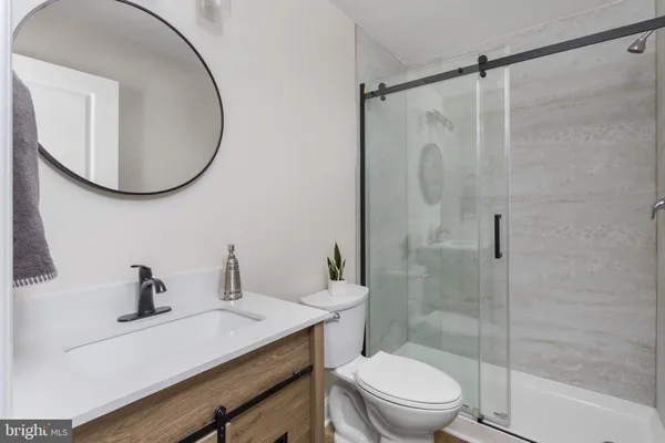 a view of a bedroom with wooden floor and a sink