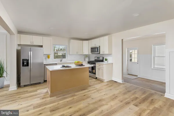 a living room with furniture and kitchen view