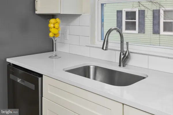 a kitchen with sink a refrigerator and cabinets