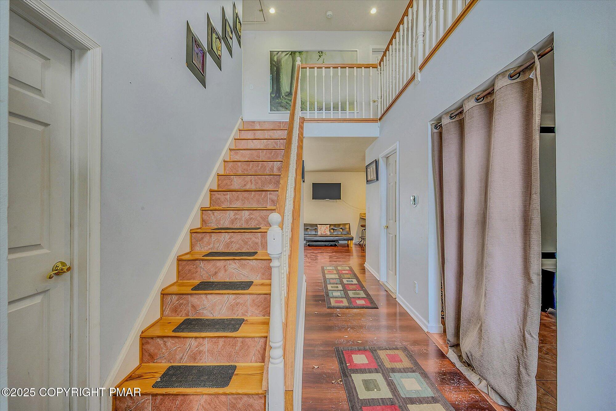 161 Beaver Dam Road Long Pond, PA 18334 - Photo 13 of 53 a view of staircase with lots of frames on wall and a rug