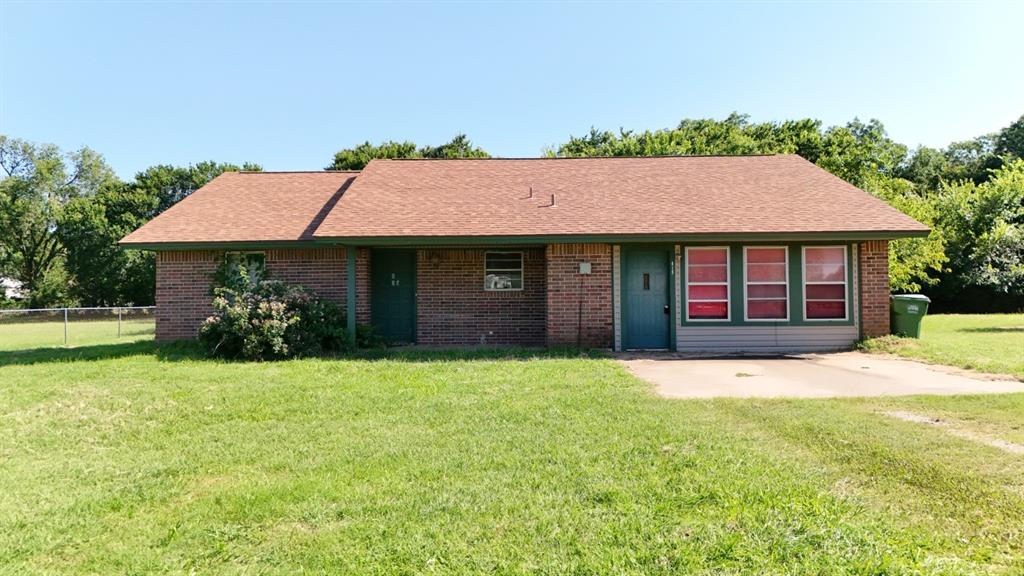 415 Meadowlark Trail Springtown, TX 76082 - Photo 1 of 40 a front view of a house with a garden and yard