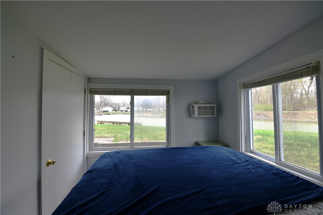 5445 Behm Road, Unit 15 Celina, OH 45822 - Photo 22 of 49 This cozy bedroom offers serene water views, creating a peaceful retreat.