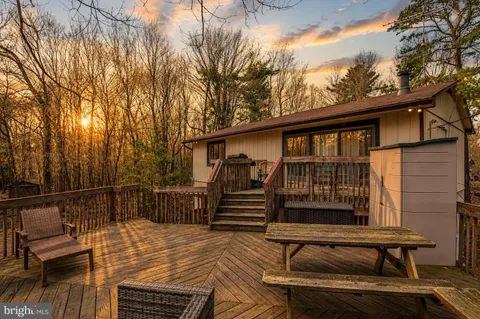 a view of a roof deck with wooden floor and fence