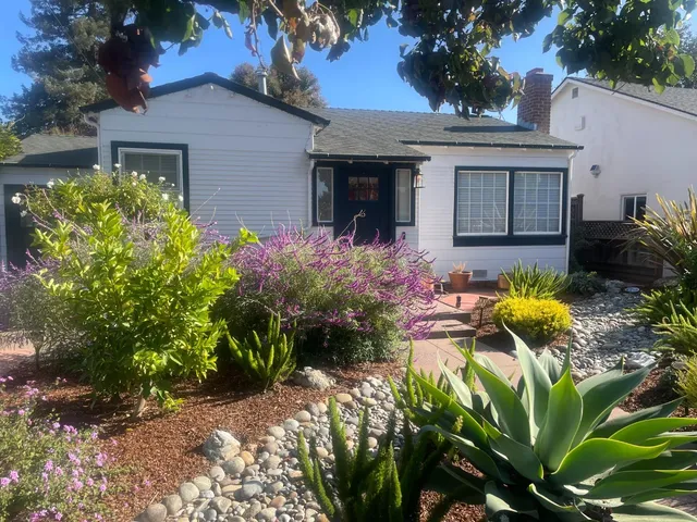 a front view of a house with garden