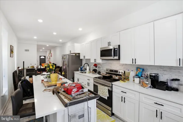 a kitchen with a sink stove and microwave