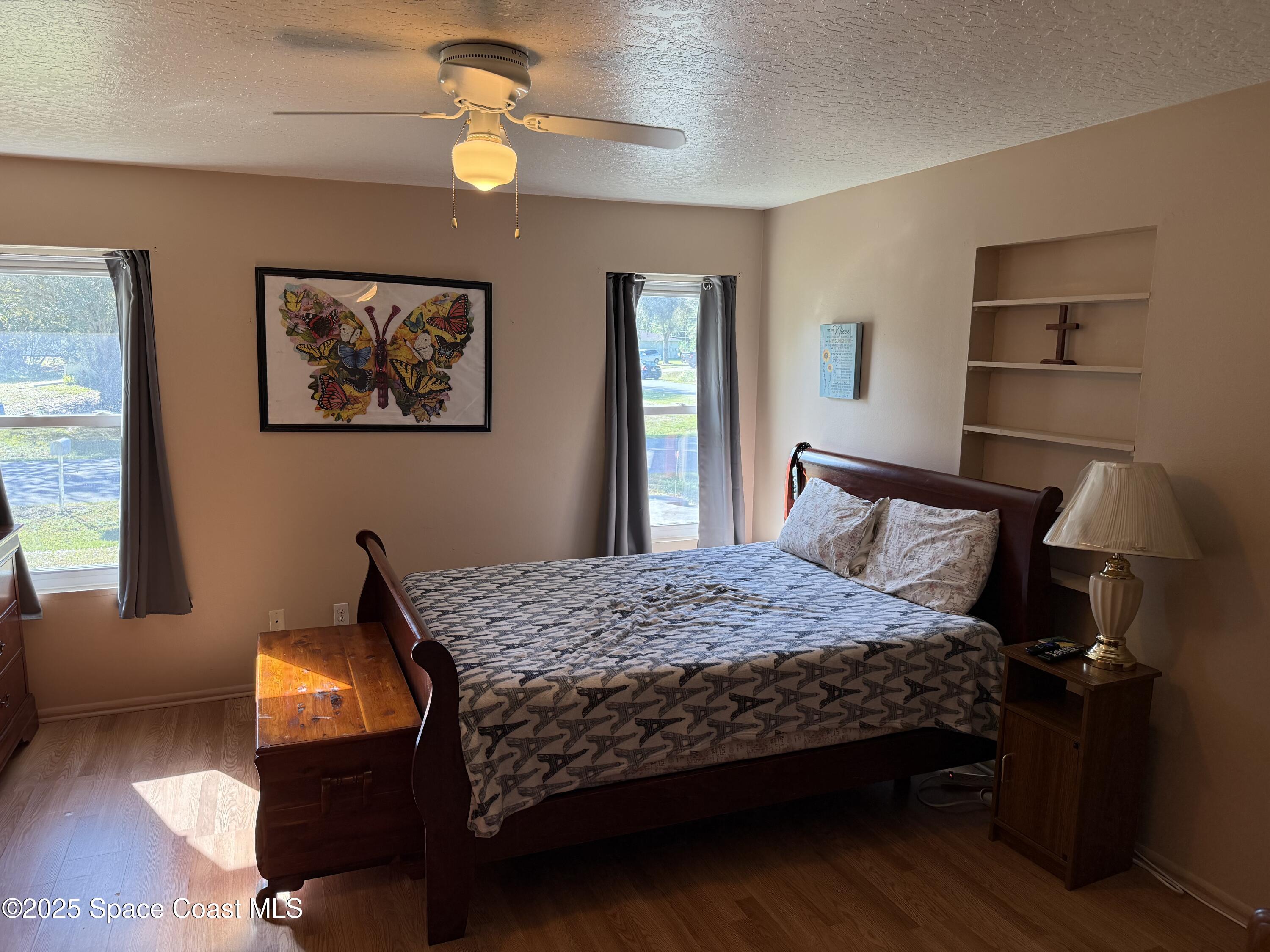 649 Waterside Road Southeast Palm Bay, FL 32909 - Photo 11 of 24 a bedroom with a bed and wooden floor