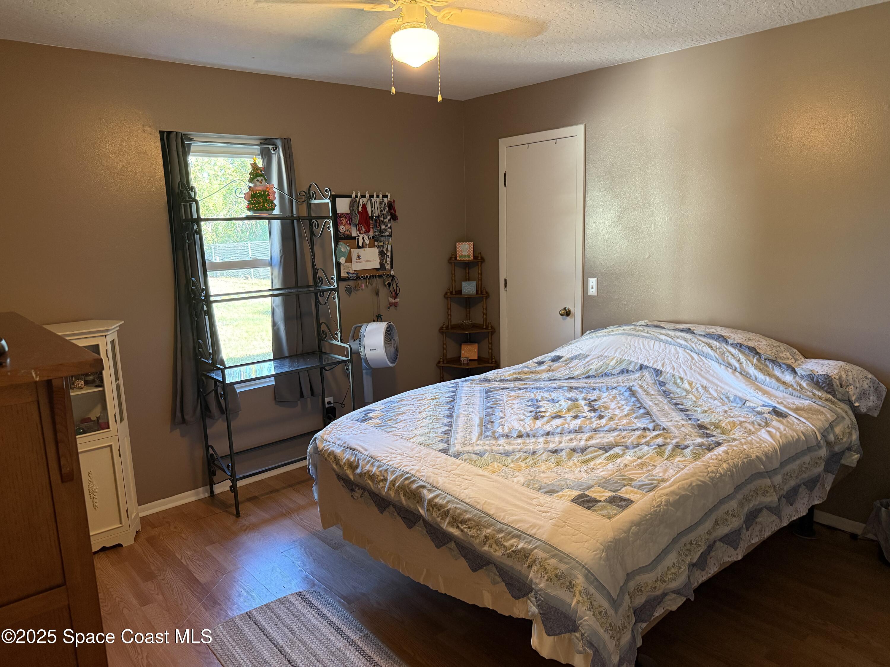 649 Waterside Road Southeast Palm Bay, FL 32909 - Photo 15 of 24 a bed sitting in a bedroom next to a window