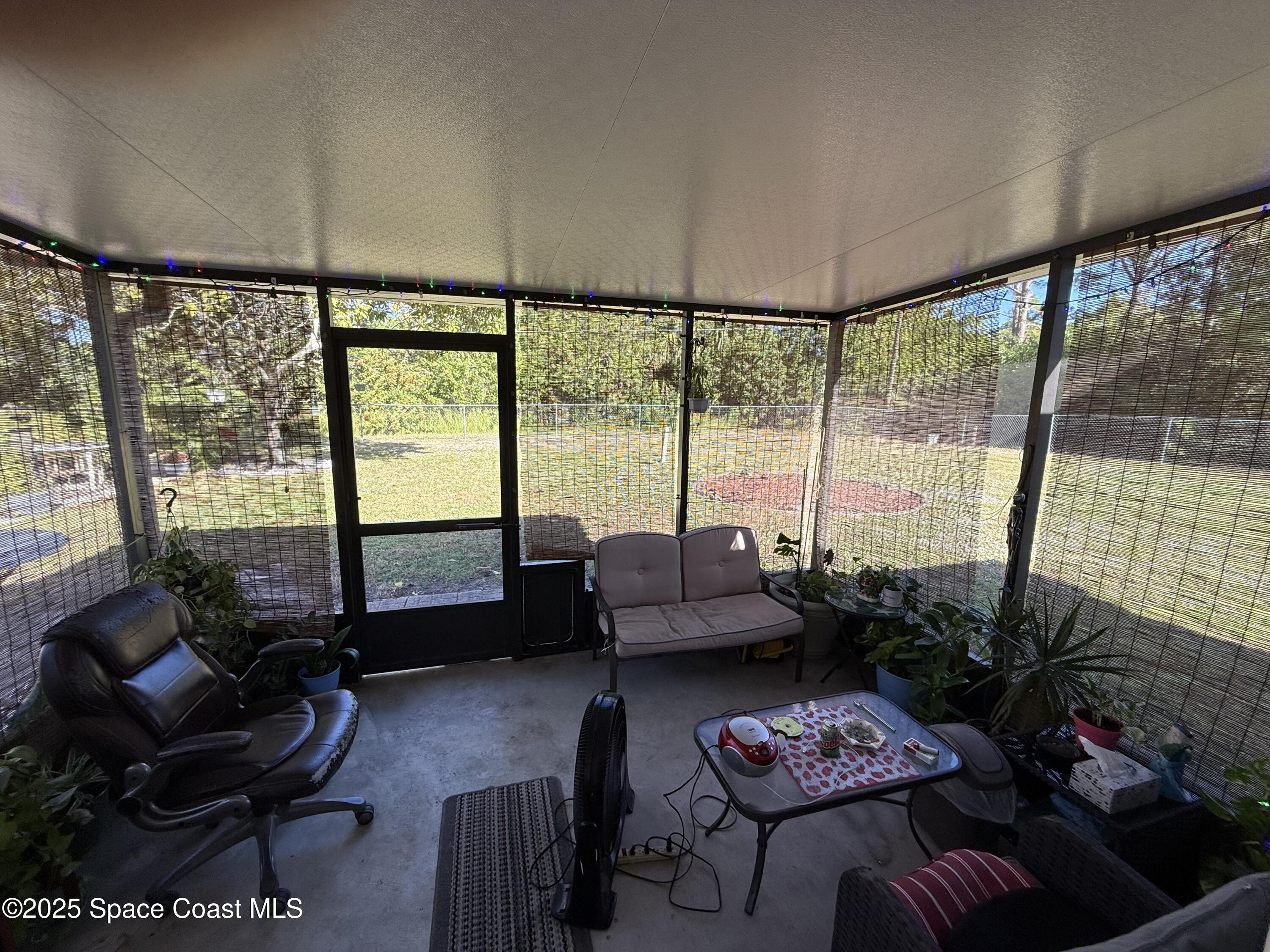 649 Waterside Road Southeast Palm Bay, FL 32909 - Photo 19 of 24 a living room with furniture and a floor to ceiling window