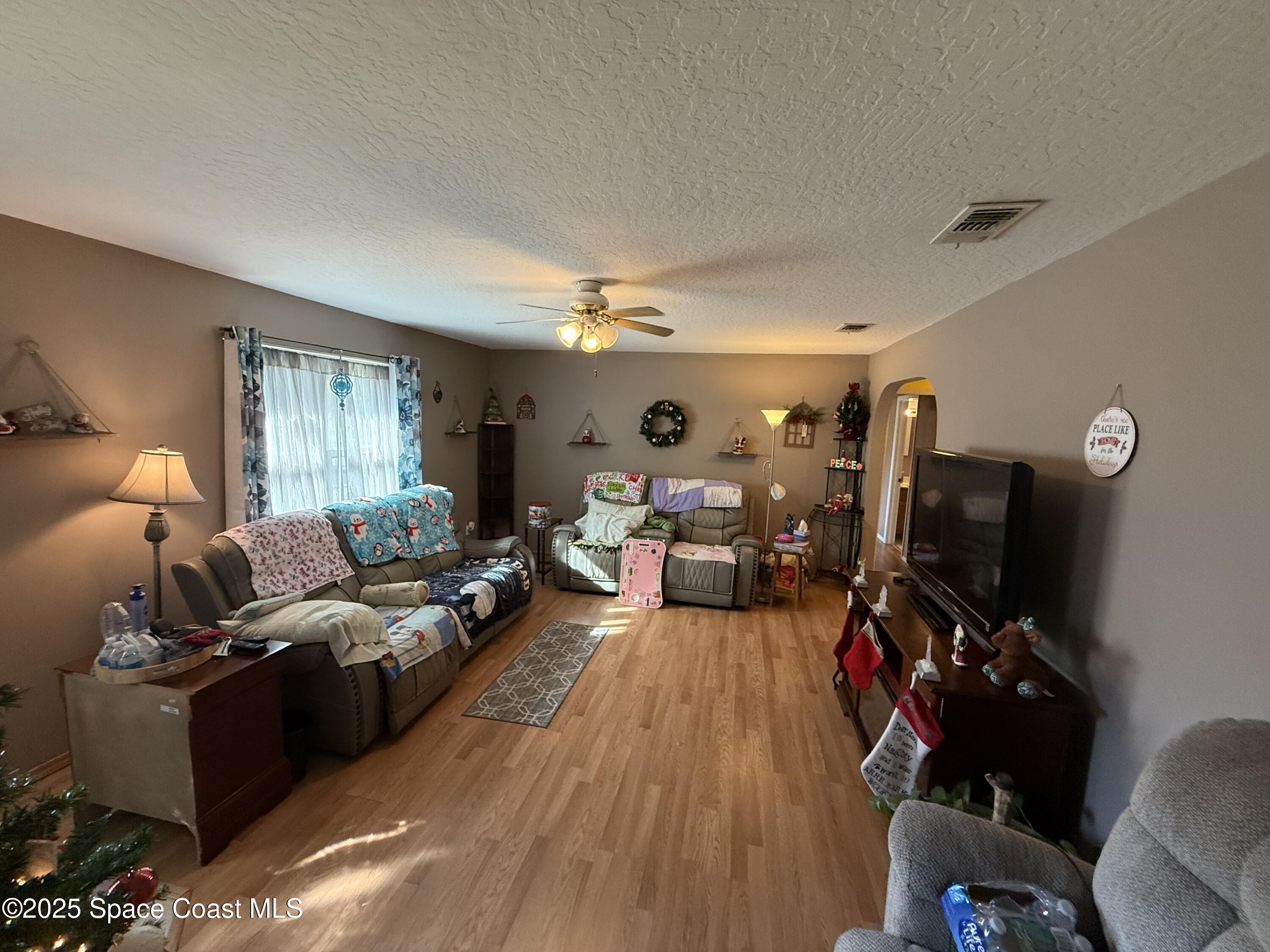 649 Waterside Road Southeast Palm Bay, FL 32909 - Photo 10 of 24 a living room with furniture and a flat screen tv