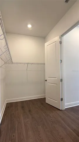 an empty room with a ceiling fan and window