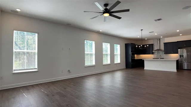 a view of a room with shelf and wooden floor