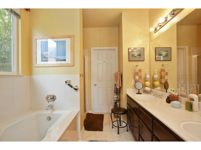 538 Monterey Road, Unit A Pacifica, CA 94044 - Photo 13 of 18 a bathroom with a sink a mirror a bathtub and shower