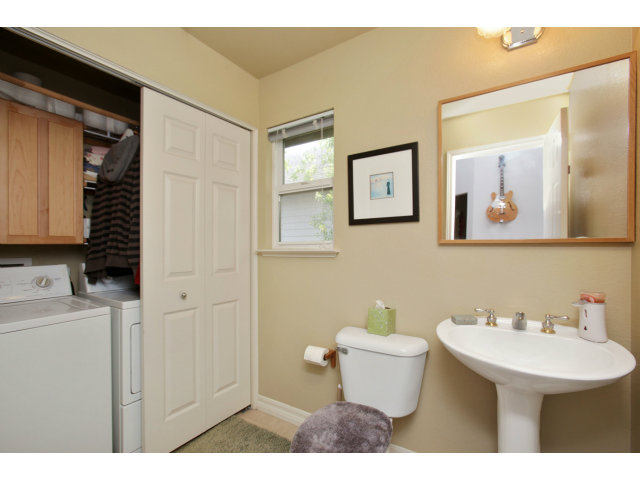 538 Monterey Road, Unit A Pacifica, CA 94044 - Photo 15 of 18 a bathroom with a toilet sink and mirror