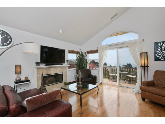 538 Monterey Road, Unit A Pacifica, CA 94044 - Photo 2 of 18 a living room with furniture a fireplace and a flat screen tv