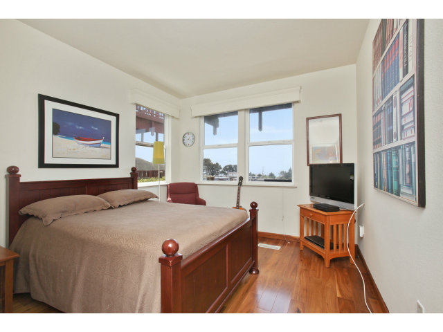 538 Monterey Road, Unit A Pacifica, CA 94044 - Photo 9 of 18 a bed room with a bed and a flat screen tv