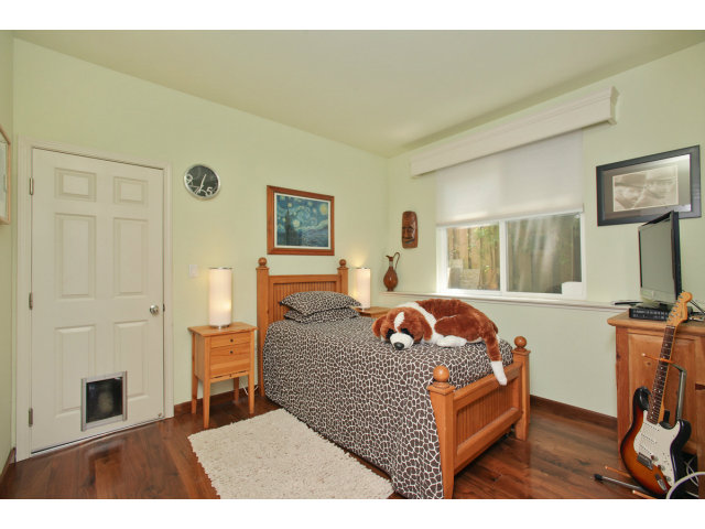 538 Monterey Road, Unit A Pacifica, CA 94044 - Photo 10 of 18 a bedroom with a bed and wooden floor