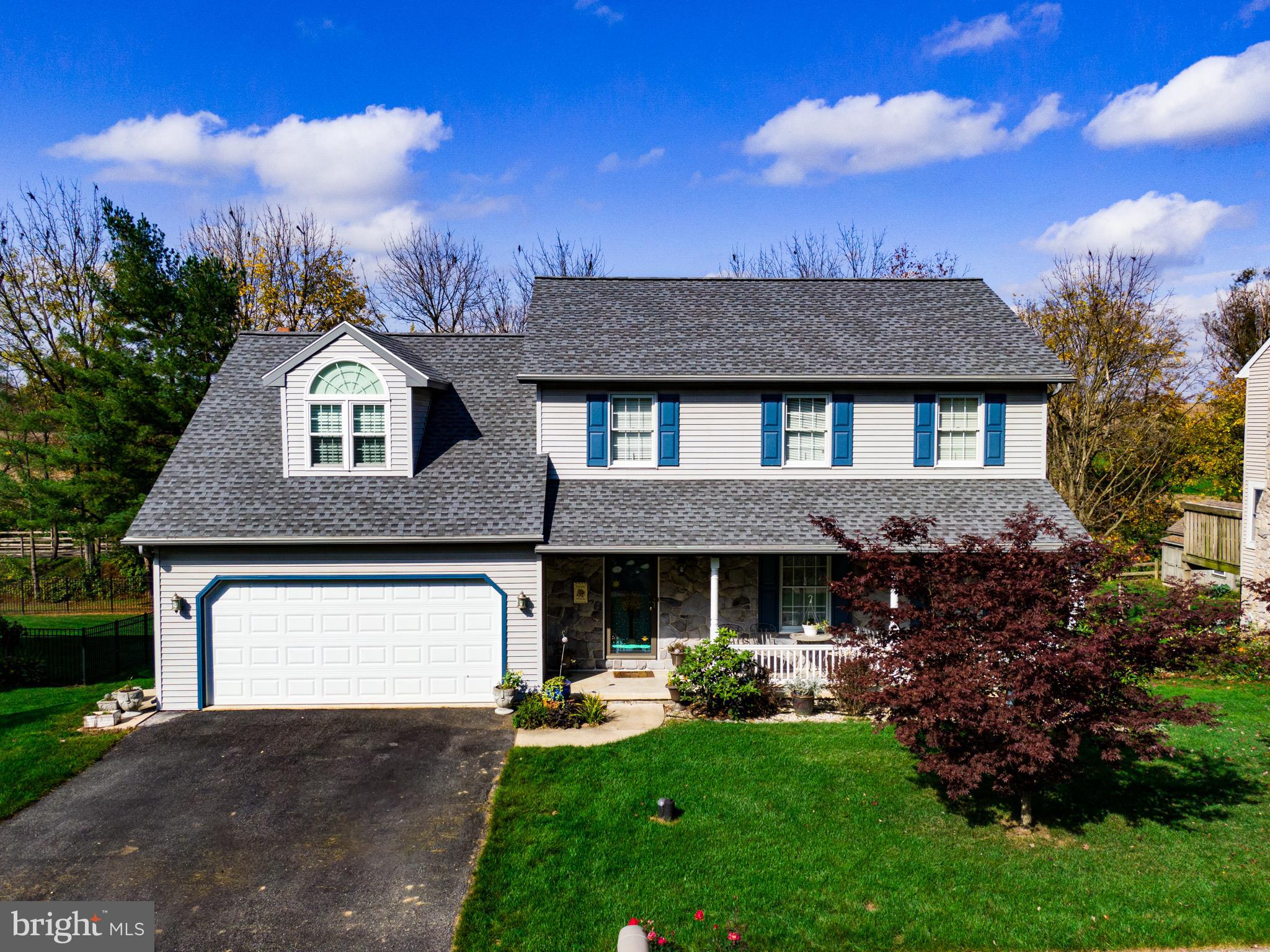 213 Bomberger Road Akron, PA 17501 - Photo 1 of 38 a front view of a house with a garden and yard