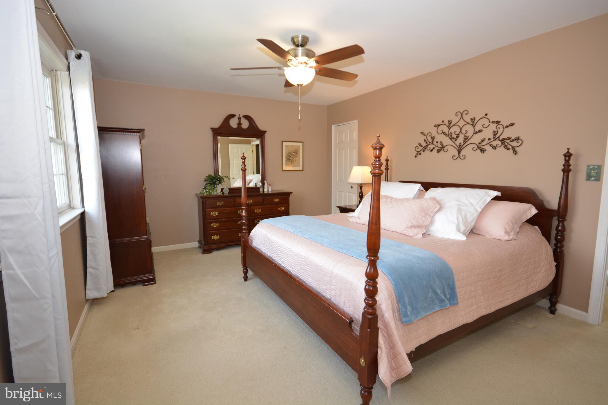 213 Bomberger Road Akron, PA 17501 - Photo 20 of 38 a bedroom with a large bed and a chandelier
